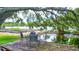 Outdoor dining area set near a pond and garden, perfect for enjoying nature's tranquility at 6501 62Nd N St, Pinellas Park, FL 33781