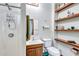 A clean bathroom featuring a walk-in shower, vanity and open shelving at 6501 62Nd N St, Pinellas Park, FL 33781