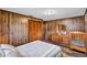 Cozy bedroom features wood paneled walls, wood-look flooring, and a large closet at 6501 62Nd N St, Pinellas Park, FL 33781