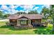 Exterior shot of home featuring stone accents, a bay window, and a surrounding green lawn at 6501 62Nd N St, Pinellas Park, FL 33781