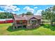 Charming rustic home with a wooden porch, stone accents, and beautifully landscaped surroundings at 6501 62Nd N St, Pinellas Park, FL 33781