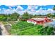 Lush gardens and charming outbuildings create a picturesque landscape in this verdant backyard at 6501 62Nd N St, Pinellas Park, FL 33781