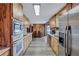 Spacious kitchen with stainless steel appliances, wood cabinets, and wood-look floors at 6501 62Nd N St, Pinellas Park, FL 33781