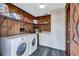 Laundry room with wood paneled walls, vinyl flooring, washer, and dryer at 6501 62Nd N St, Pinellas Park, FL 33781
