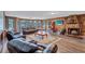 Cozy living room featuring a stone fireplace, wood paneling, and comfortable seating at 6501 62Nd N St, Pinellas Park, FL 33781