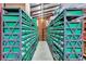 A long storage room is shown with rows of green storage bins at 6501 62Nd N St, Pinellas Park, FL 33781