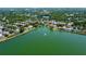 Aerial shot showing the community lake with water fountain and the homes surrounding the lake at 7123 Colonial Lake Dr, Riverview, FL 33578