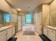 En-suite main bathroom featuring separate shower, soaking tub, and dual sink vanity at 7123 Colonial Lake Dr, Riverview, FL 33578
