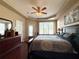 Tranquil main bedroom with tray ceilings, large window, and comfortable furnishings at 7123 Colonial Lake Dr, Riverview, FL 33578