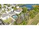 Aerial view of home featuring a screened in pool and a view of the adjacent lake at 7653 Stoney Hill Dr, Wesley Chapel, FL 33545