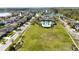 Aerial view of a large green space, a pool and clubhouse with homes and trees in the background at 7653 Stoney Hill Dr, Wesley Chapel, FL 33545