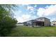 Spacious backyard featuring a screened-in pool, brick pavers, and ample green space for recreation at 7653 Stoney Hill Dr, Wesley Chapel, FL 33545