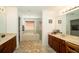 Bright primary bathroom featuring dual vanities, soaking tub, and glass-enclosed shower at 7653 Stoney Hill Dr, Wesley Chapel, FL 33545