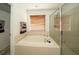 Bathroom with soaking tub, window, and glass enclosed shower at 7653 Stoney Hill Dr, Wesley Chapel, FL 33545