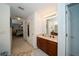 Double vanity in bathroom with dark wood cabinets and tile flooring leading to bedroom at 7653 Stoney Hill Dr, Wesley Chapel, FL 33545