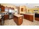 This kitchen boasts a central island, stainless steel appliances, and wood cabinets at 7653 Stoney Hill Dr, Wesley Chapel, FL 33545