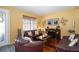 Inviting living room with hardwood floors, a cozy fireplace, and comfortable leather seating at 7653 Stoney Hill Dr, Wesley Chapel, FL 33545