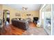 The living room features hardwood floors, ceiling fan, and access to the screened in lanai at 7653 Stoney Hill Dr, Wesley Chapel, FL 33545