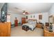 Large bedroom featuring white walls, wood furnishings, and a ceiling fan with lights at 7653 Stoney Hill Dr, Wesley Chapel, FL 33545