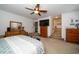 Spacious primary bedroom featuring a ceiling fan, a TV, and en suite bathroom at 7653 Stoney Hill Dr, Wesley Chapel, FL 33545