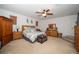 Primary bedroom featuring neutral walls, a ceiling fan, and wood bedroom furnishings at 7653 Stoney Hill Dr, Wesley Chapel, FL 33545