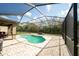 Backyard oasis with pool, brick pavers, outdoor seating, and screened-in enclosure for added privacy at 7653 Stoney Hill Dr, Wesley Chapel, FL 33545