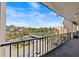 Balcony view overlooking the parking lot, tennis courts, and surrounding greenery at 90 S Highland Ave # 1317, Tarpon Springs, FL 34689