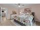 Comfortable bedroom with a floral bedspread, dresser, and light colored flooring at 90 S Highland Ave # 1317, Tarpon Springs, FL 34689