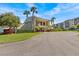 Exterior view of a building with well-maintained landscaping and a circular driveway at 90 S Highland Ave # 1317, Tarpon Springs, FL 34689