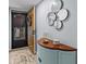 Entryway featuring a wooden door, decorative mirrors, and a charming blue cabinet at 90 S Highland Ave # 1317, Tarpon Springs, FL 34689