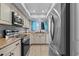 Bright kitchen featuring stainless steel appliances, sleek countertops, and a window with natural light at 90 S Highland Ave # 1317, Tarpon Springs, FL 34689