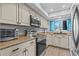 Well-lit kitchen featuring modern appliances, neutral-toned cabinets, and stylish countertops at 90 S Highland Ave # 1317, Tarpon Springs, FL 34689