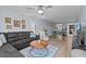 Open-concept living room with wood-style flooring, comfortable seating, and ample natural light throughout at 90 S Highland Ave # 1317, Tarpon Springs, FL 34689