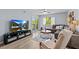 Bright living room with sliding glass doors to the outside, comfortable seating, and modern entertainment center at 90 S Highland Ave # 1317, Tarpon Springs, FL 34689