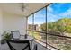 Screened patio with views of landscaped grounds and building in the distance at 90 S Highland Ave # 1317, Tarpon Springs, FL 34689