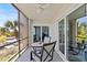 Screened patio with ceiling fan and sliding glass doors at 90 S Highland Ave # 1317, Tarpon Springs, FL 34689