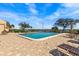 Community pool with lounge chairs and lake view at 90 S Highland Ave # 1317, Tarpon Springs, FL 34689