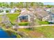 This home features a screened-in lanai, a peaceful view of the water, and landscaping for ultimate relaxation at 9426 Green Needle Dr, New Port Richey, FL 34655