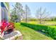 Secluded backyard with lush greenery and views of the golf course and pond, creating a private retreat at 9426 Green Needle Dr, New Port Richey, FL 34655