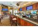 Inviting bar area with counter seating, multiple TVs, and a wide selection of beverages at 9426 Green Needle Dr, New Port Richey, FL 34655