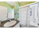 Bright bathroom with lime-green walls, a shower-tub combo, and a patterned shower curtain for a unique style at 9426 Green Needle Dr, New Port Richey, FL 34655