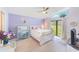 Tranquil bedroom with light purple walls, a white bed frame, and natural light from a large window at 9426 Green Needle Dr, New Port Richey, FL 34655