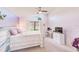 Bedroom with light purple walls features a white bed, a desk, and large windows for ample light at 9426 Green Needle Dr, New Port Richey, FL 34655