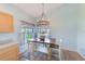 A charming dining area features a rustic table, stylish lighting, and neutral wall color at 9426 Green Needle Dr, New Port Richey, FL 34655