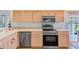 The kitchen features stainless steel appliances, light wood cabinets, and neutral countertops at 9426 Green Needle Dr, New Port Richey, FL 34655