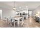 Open-concept dining room flowing into a kitchen with white cabinets and granite countertops at 9743 Sage Creek Dr, Ruskin, FL 33573