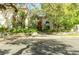 Charming building exterior with mature trees, landscaping, and a decorative façade at 1012 Pearce Dr # 105, Clearwater, FL 33764
