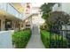 Courtyard and staircase featuring well-manicured landscaping and a secure gate at 1012 Pearce Dr # 105, Clearwater, FL 33764