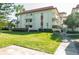 Multi-story condo building with red tile roof, balconies, and well-maintained landscaping at 1012 Pearce Dr # 105, Clearwater, FL 33764