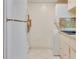 A kitchen featuring white appliances, neutral countertops, and square tiled backsplash with a washer/dryer combo at 1012 Pearce Dr # 105, Clearwater, FL 33764